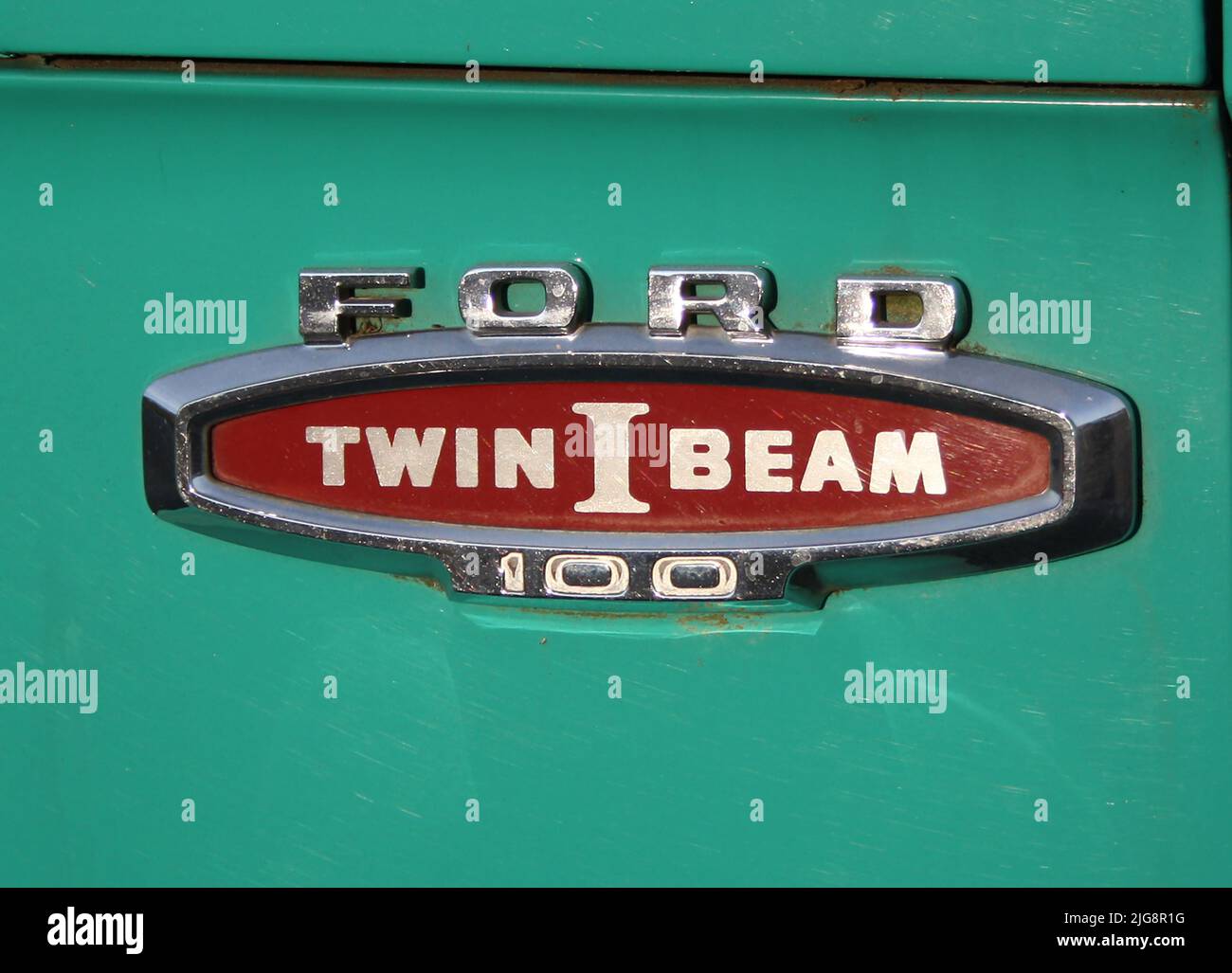a logo of Vintage Ford Twin I Beam 100 on green background Stock Photo
