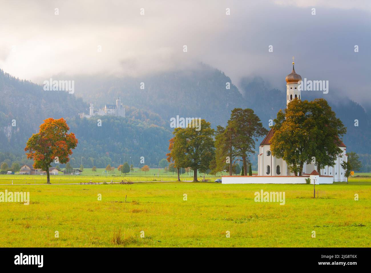 Saint Koloman Church with Neuschwanstein Castle in the background, near Fussen, Allgäu, Bavaria, Germany Stock Photo