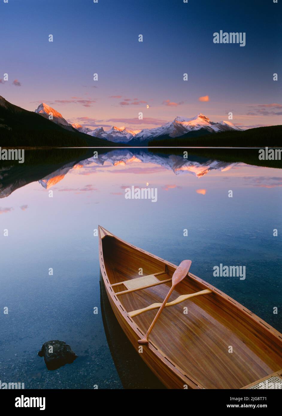 Canoe on Maligne Lake at Sunset, Jasper National Park, Alberta, Canada Stock Photo