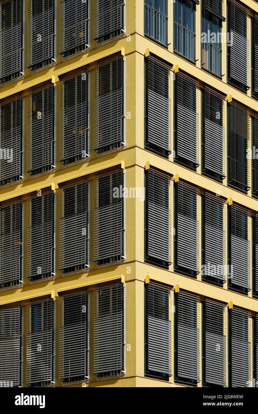 Germany, Bavaria, Munich, office building, yellow facade, sun blinds, detail Stock Photo