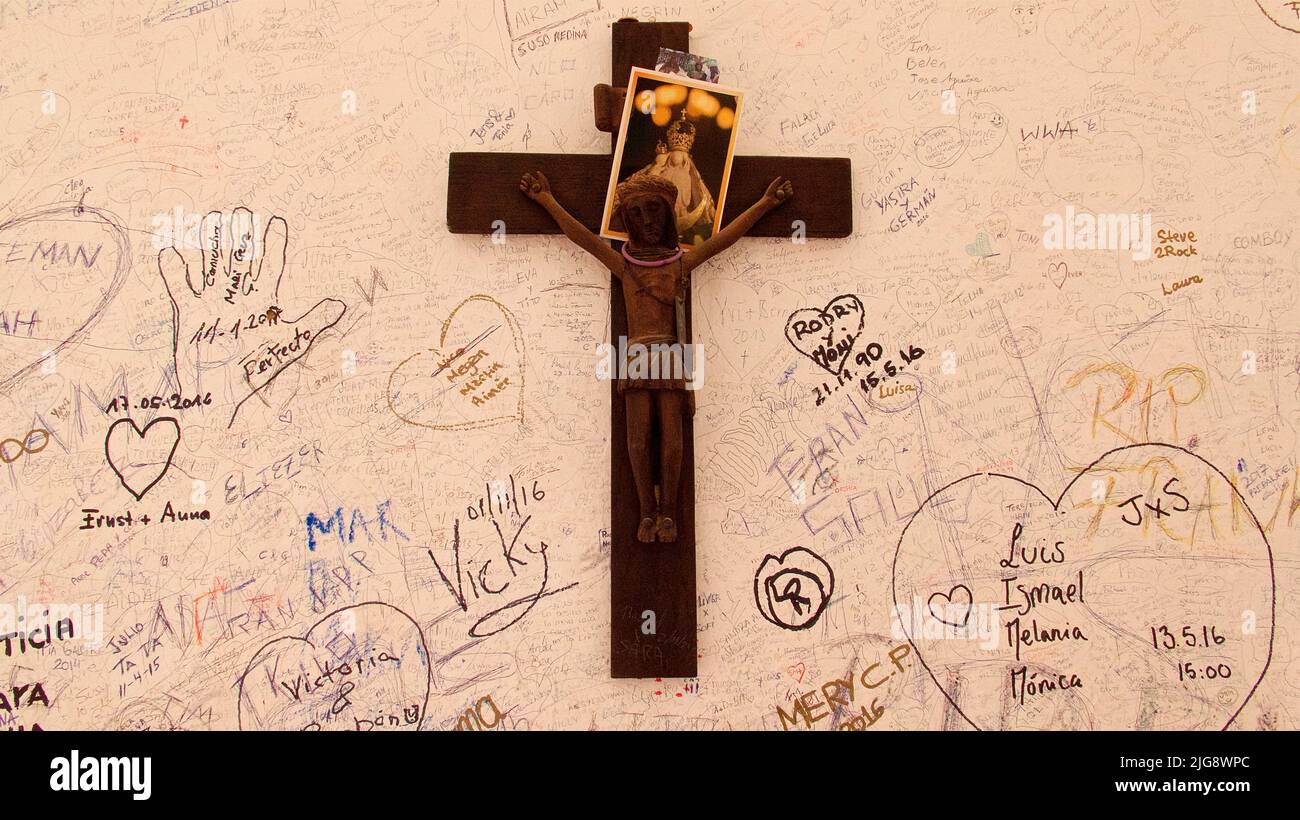 Spain, Canary Islands, Fuerteventura, Barranco de las Penitas, Ermita de la Pena, crucifix on white wall, image of saint, painted wall Stock Photo