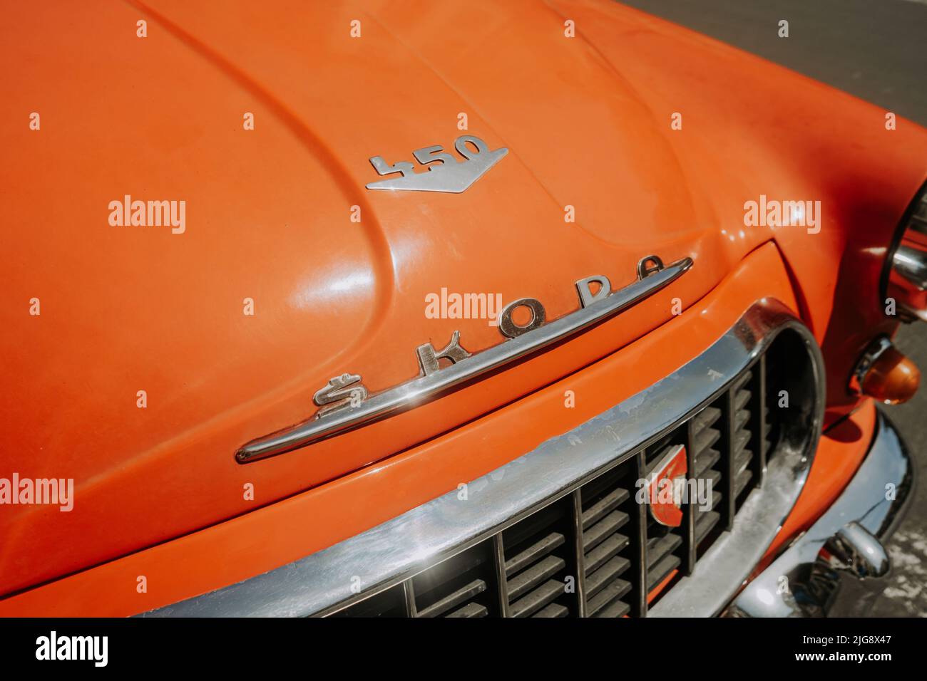 Prague, CZECH REPUBLIC - July 2022. Detail of retro Skoda automobile brand, logo close-up view. 450 orange roadster. Symbol of Czech vintage car maker Stock Photo