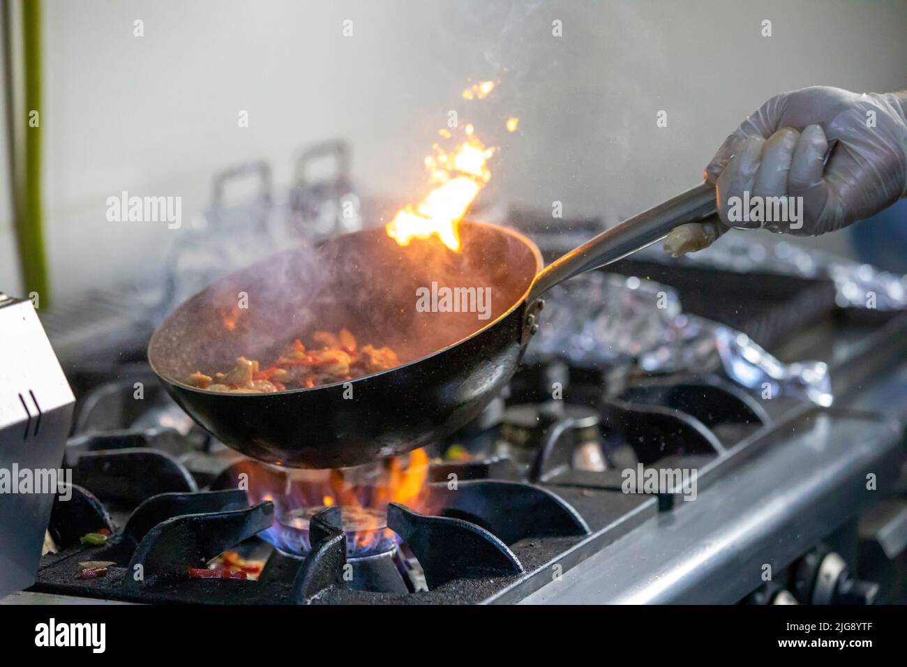 Chef cooking in kitchen stove Stock Photo