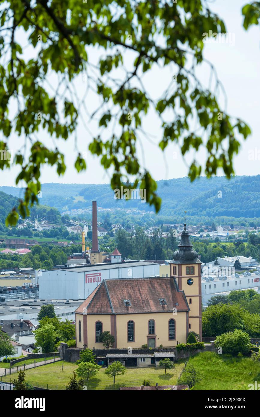 Breuberg, Hesse, Germany, view of the Lutheran parish church in the Sandbach district of Breuberg. In the background the Pirelli factory. Stock Photo