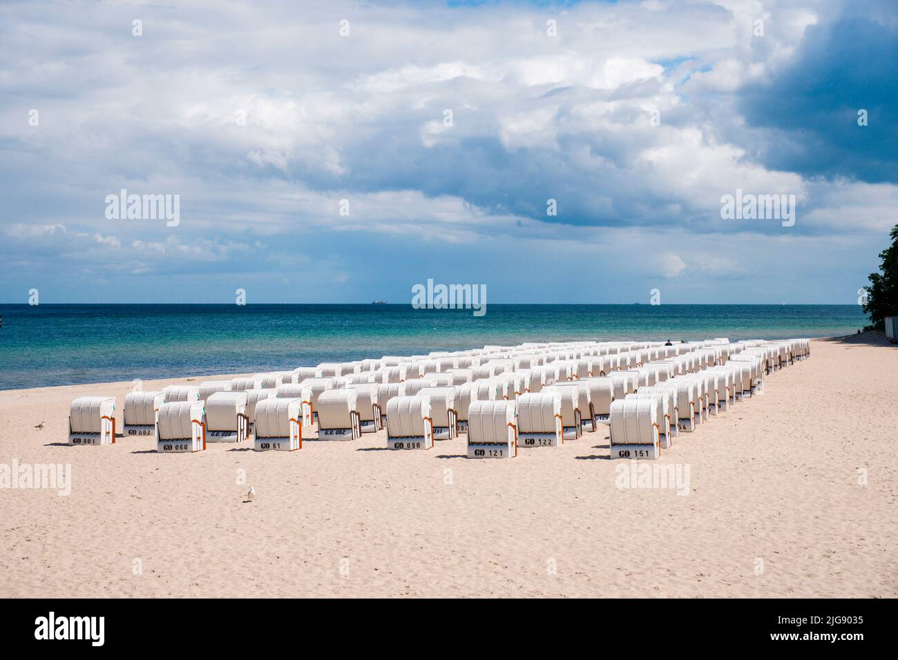 Beach chairs lined up side by side on the beach of the Baltic Sea Stock Photo