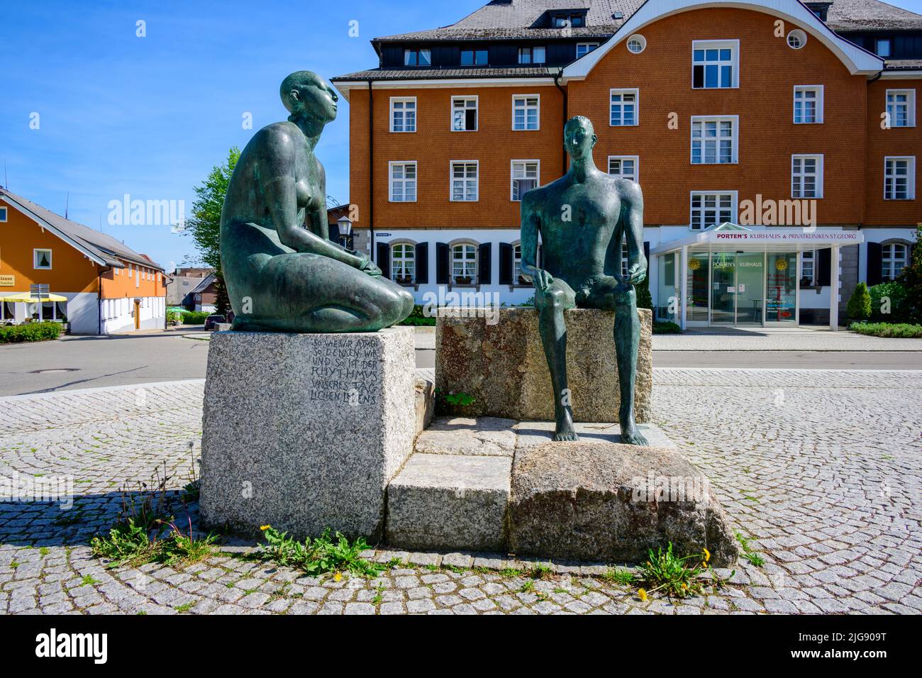 Germany, Baden-Württemberg, Black Forest, Höchenschwand, sculpture 'The Two Resting' on the Kurhausplatz. Stock Photo