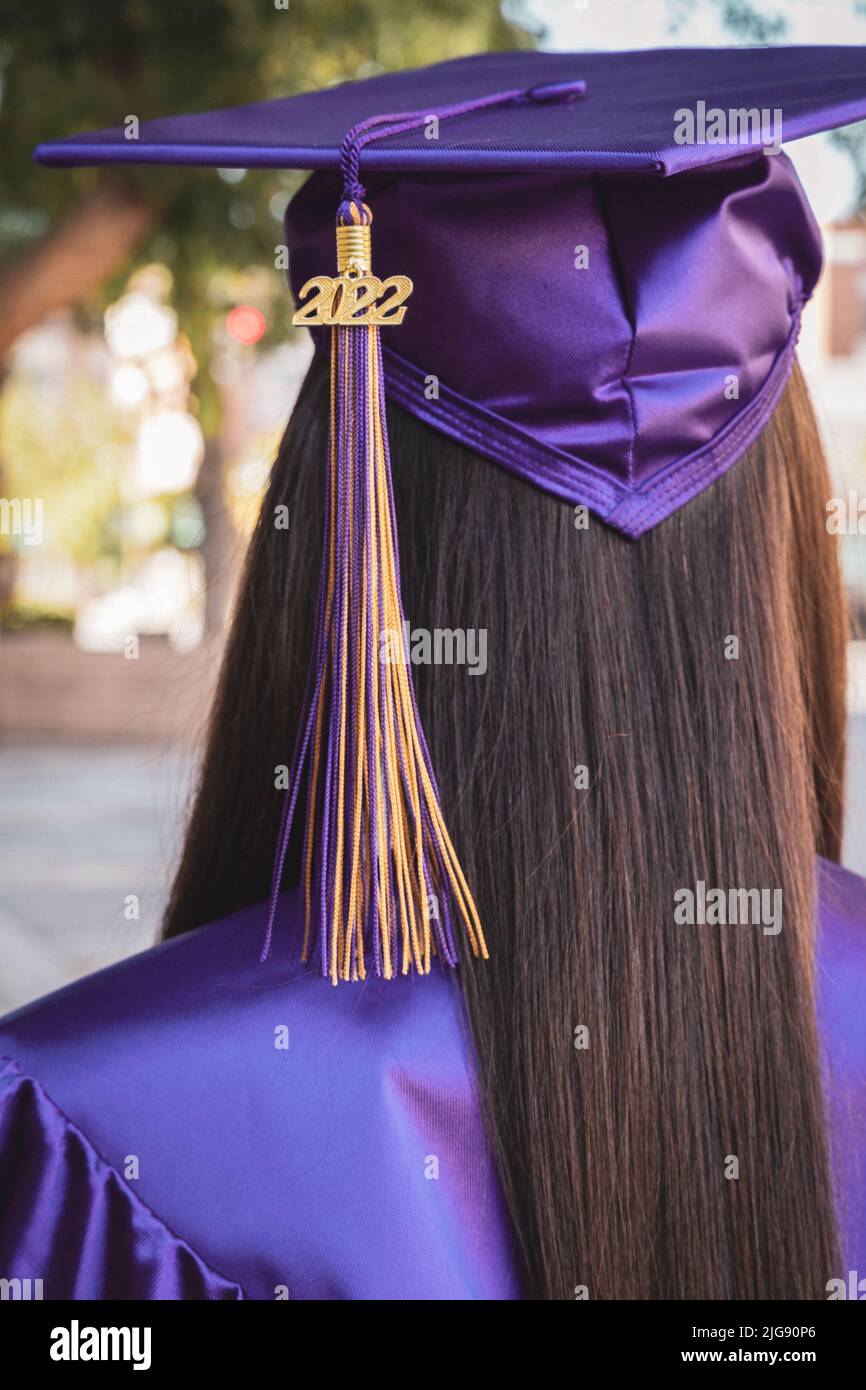 A girl in a purple graduation gown from behind Stock Photo - Alamy