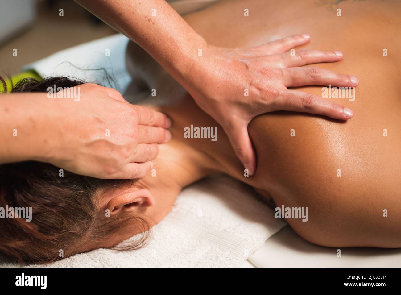 woman receiving a massage of the cervical area Stock Photo
