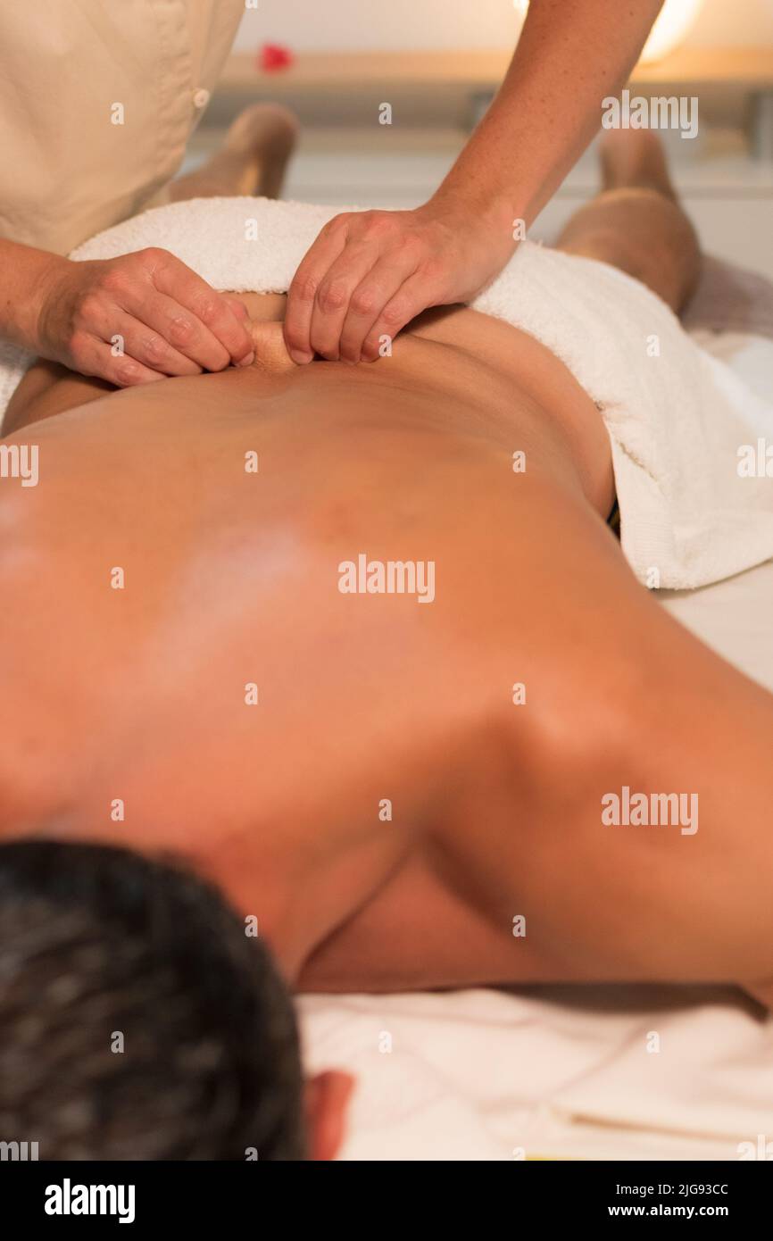 man receiving lower back massage Stock Photo