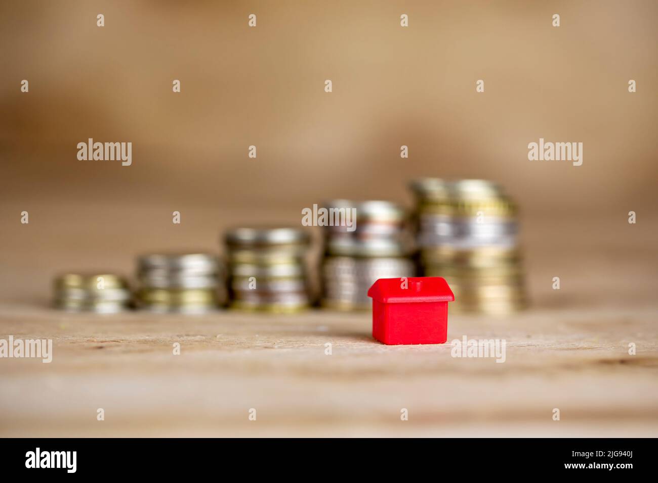 House on stack of coins. Concept of Investment property and mortgage Stock Photo