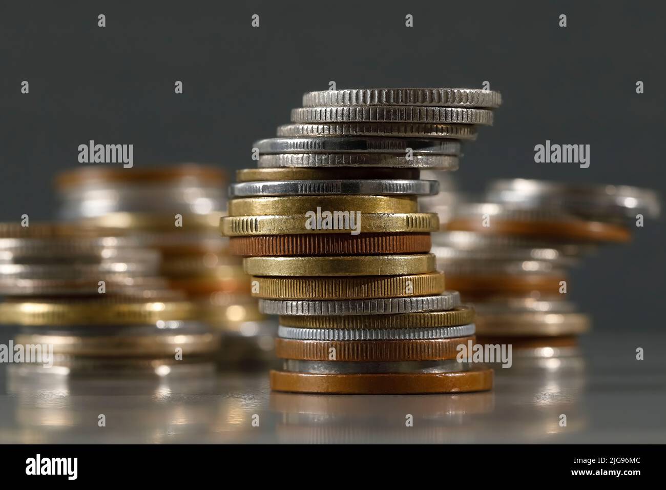 Group of various coins against gray background. Stock Photo