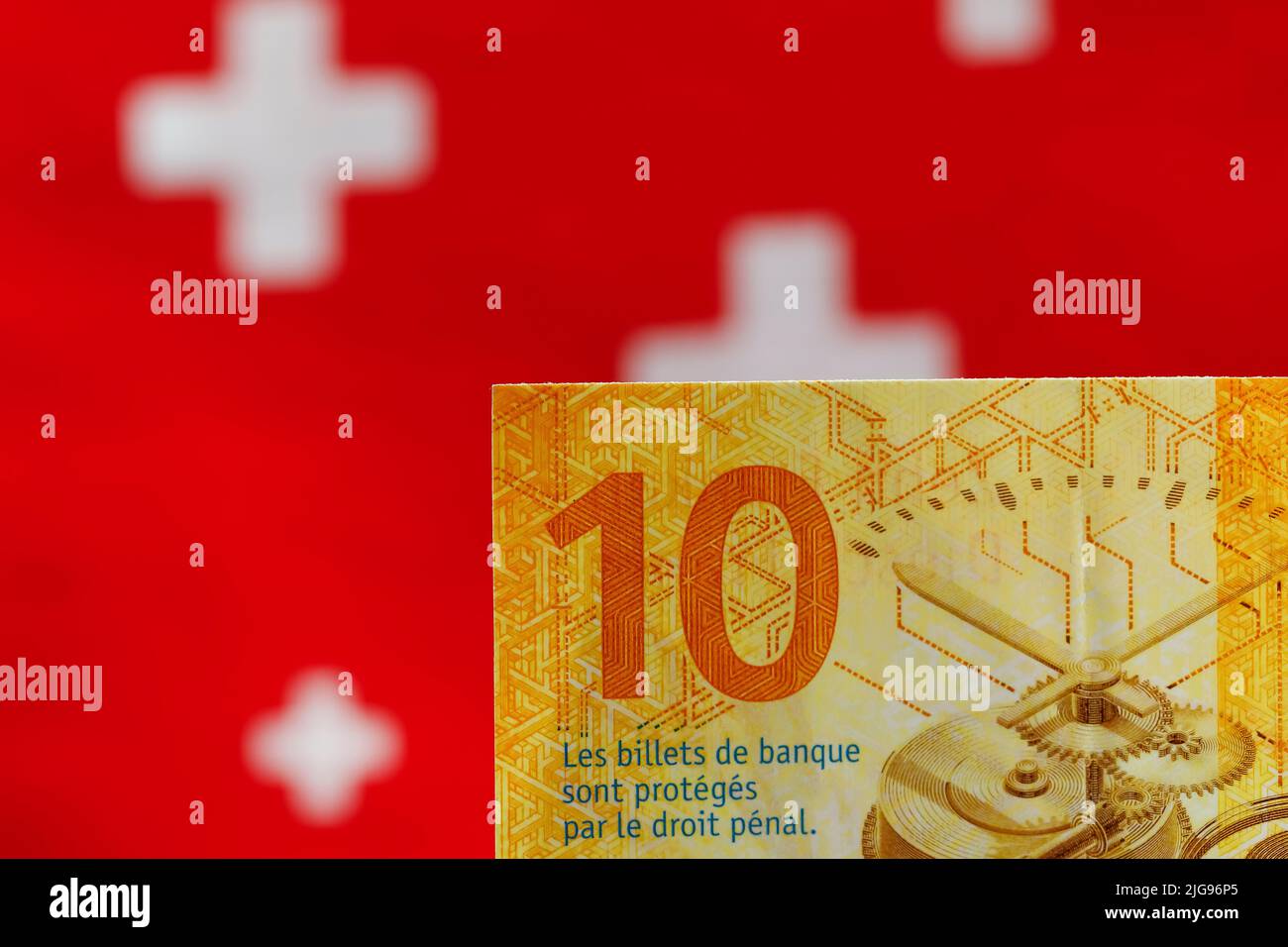 Ten Swiss francs banknote, and the flag symbols are visible in the background. This is new money and this is the eighth series of Swiss banknotes that Stock Photo