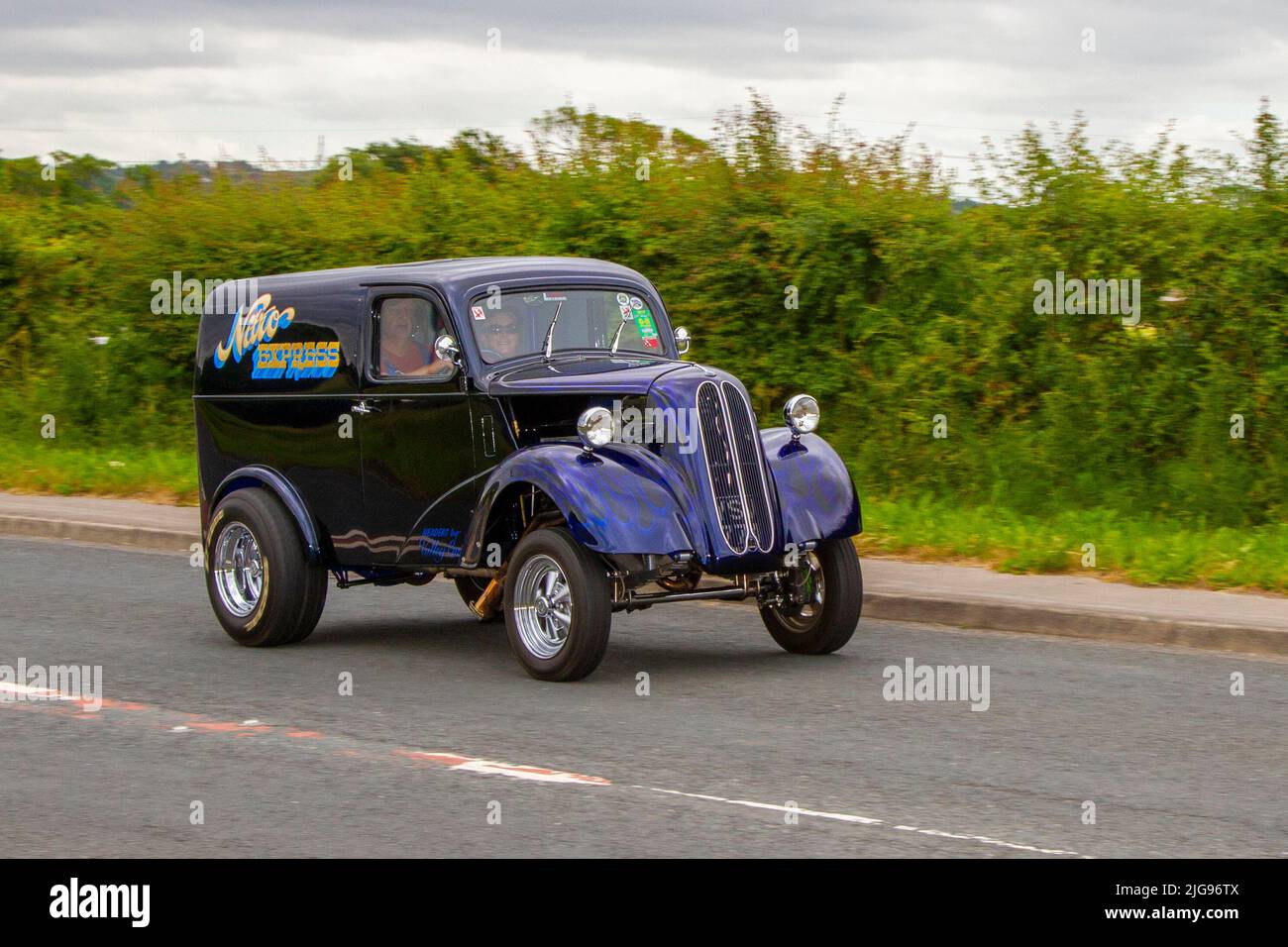 117 Fordson 8 Van (Mod Hot Rod) Van. 1948 40s blue purple forties Ford Anglia 'Nitro Express' based on Fords 5cwt Van. Hot rods cars, drag cars, ANGLIA, hot rod, retro, drag racing, race gasser, street rods. Modified cars en-route to Hoghton Tower for the Supercar Summer Showtime car meet which is organised by Great British Motor Shows in Preston, UK Stock Photo