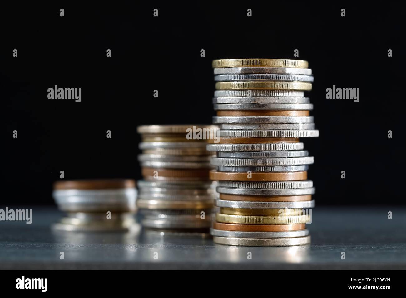 Money, in this case group of various stacked coins, represents an improvement in the economic situation. Stock Photo