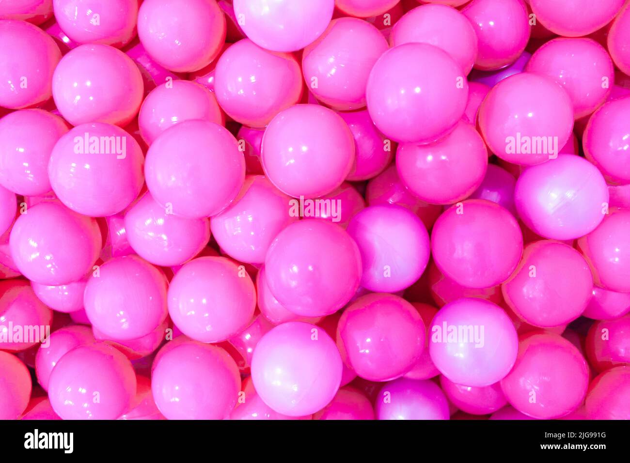 Pink plastic balloons. Isolated pink color background. Monochromatic concept. Stock Photo