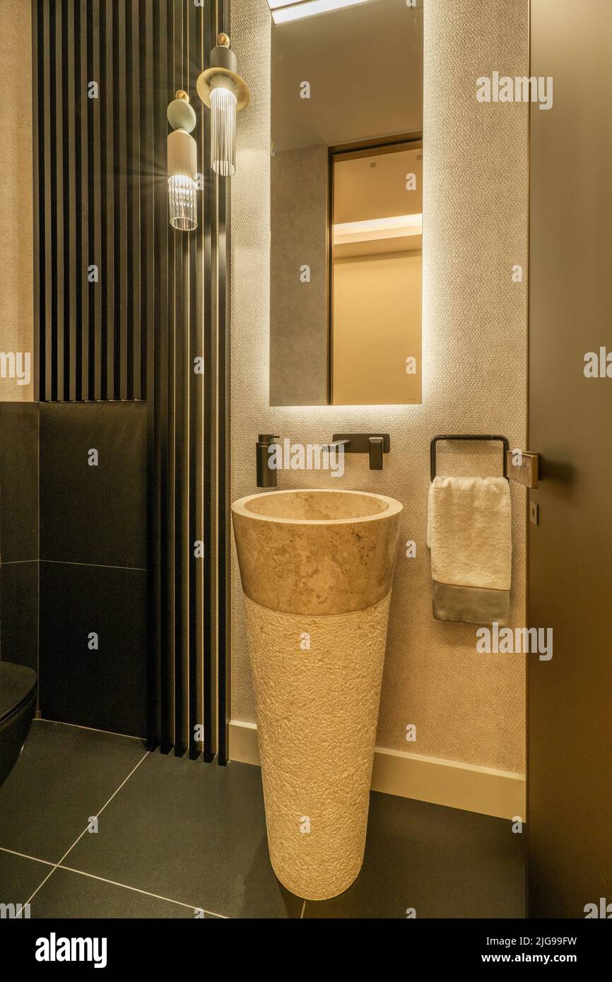 Small cloakroom in modern design furniture with brown marble sink