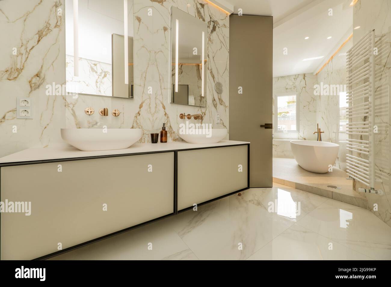 Bathroom with a large hanging cabinet with separate porcelain sink, two ...
