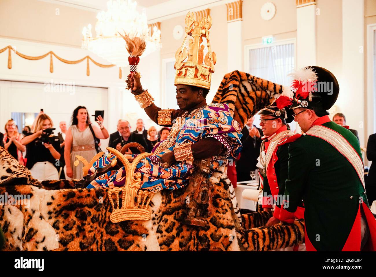 08 July 2022, Rhineland-Palatinate, Bad Dürkheim: Céphas Bansah, African king residing in Rhineland-Palatinate, is carried into the ballroom on a palanquin at the "Golden Winemaker" award ceremony of the "Derkemer Grawler" carnival society in the Kurhaus. Prominent persons are distinguished, who made themselves meritorious in socially important areas. Bansah has lived in Ludwigshafen since 1970 and cares for more than 300,000 people from the Ewe tribe in Ghana from a distance. Photo: Uwe Anspach/dpa Stock Photo