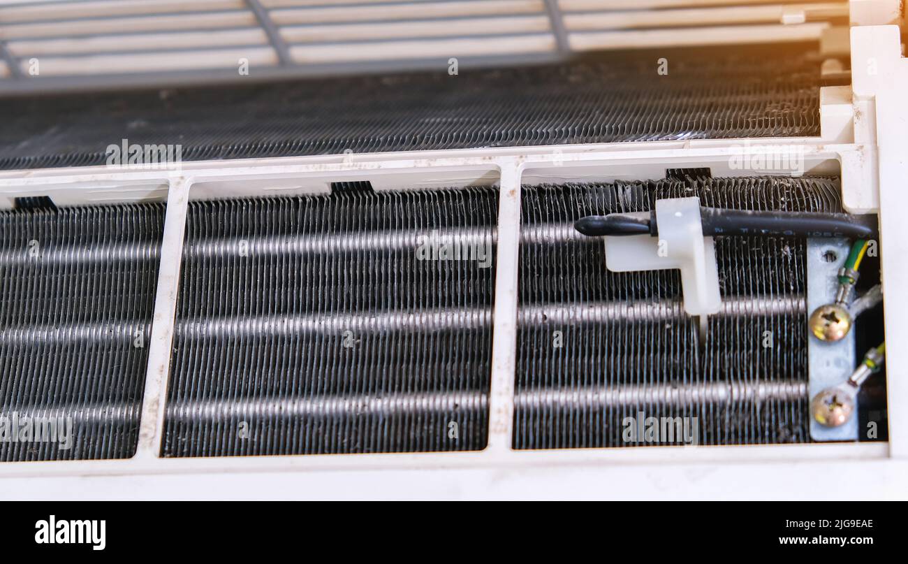 A man disassembles an air conditioner for cleaning. Split system maintenance Stock Photo Alamy