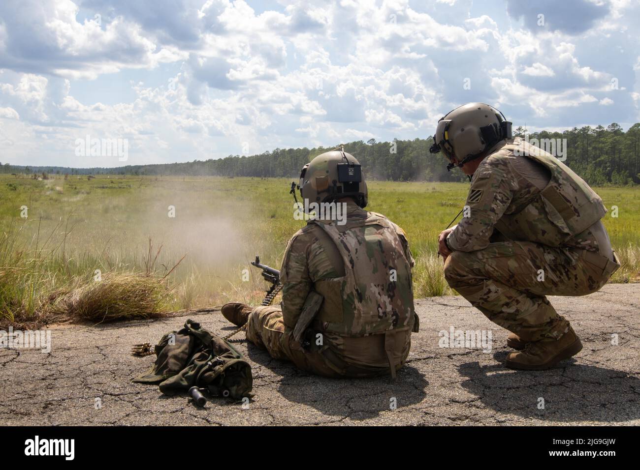 Soldiers assigned to 2nd Battalion, 3rd General Support Aviation Battalion, 3rd Combat Aviation Brigade, 3rd Infantry Division, shoot an M240H Machine Gun during aerial gunnery at Fort Stewart, Georgia, July 6, 2022. Soldiers first qualify with their weapons on the ground before moving to the aerial portion of the qualification. (U.S. Army photo by Spc. Caitlin Wilkins, 3rd Combat Aviation Brigade) Stock Photo