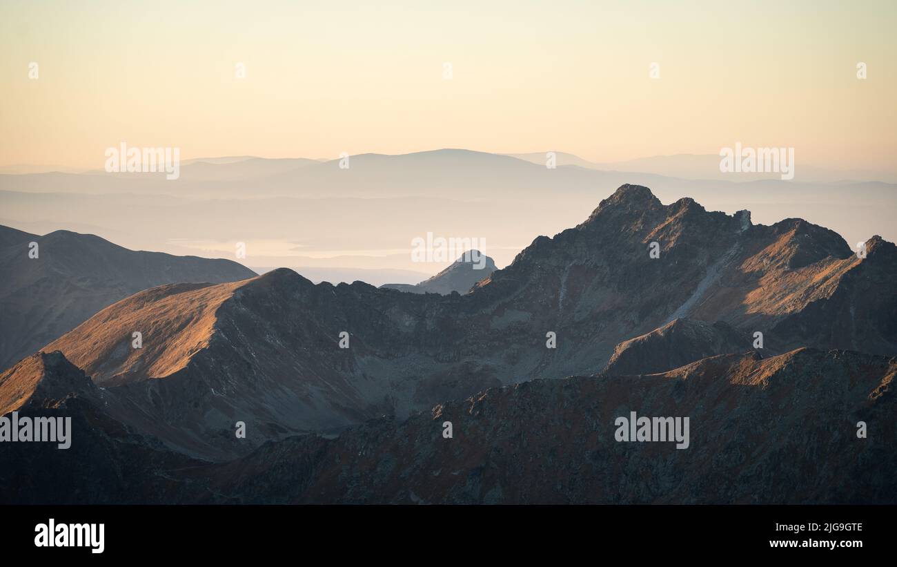 Alpine landscape with mountain ranges, peaks catching last light during sunset, Europe, Slovakia Stock Photo