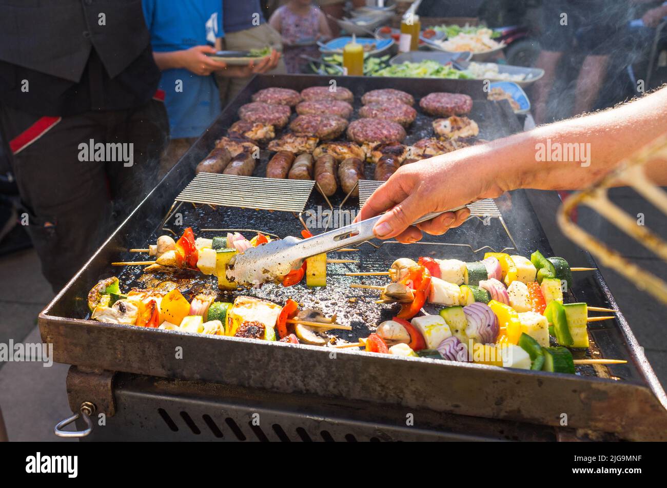 Cooking food on a barbeque hotplate Stock Photo