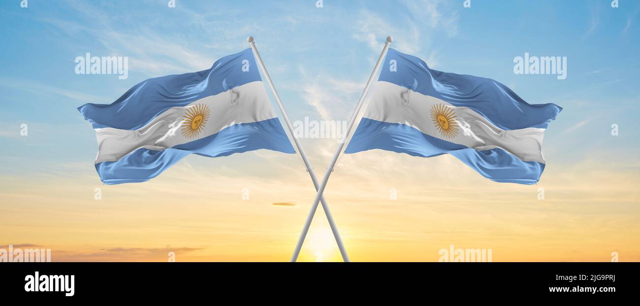 crossed national flags of Argentine and Argentina flag waving in wind ...