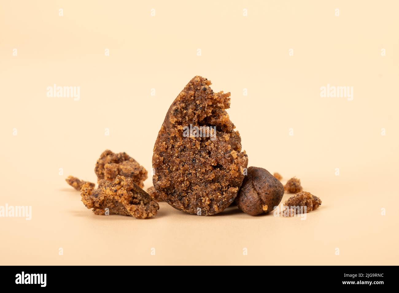 high thc extract, crumbled cannabis hashish slices on beige background. Stock Photo
