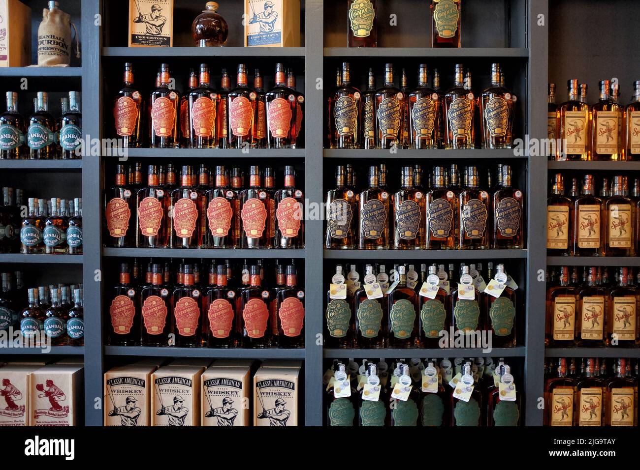 COOPERSTOWN, NEW YORK - 21 JUNE 2021: Wall of baseball themed spirits at Cooperstown Distillery the only distillery in Otsego County, near the Nationa Stock Photo