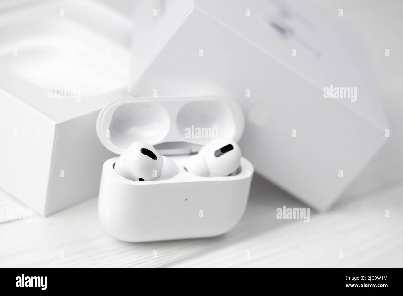 UKRAINE JANUARY 2021: Apple AirPods Pro on a white background. Wireless headphones with charging case and a box. Apple Inc. is an Ameri Stock Photo - Alamy