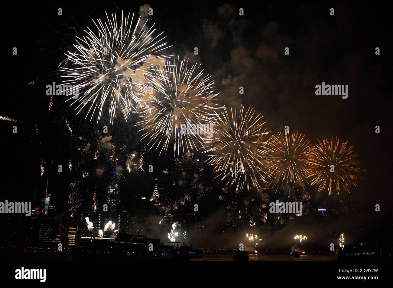 The Macy's Fourth of July fireworks on the East River as seen from the deck of Clipper City. July 4, 2022 Stock Photo