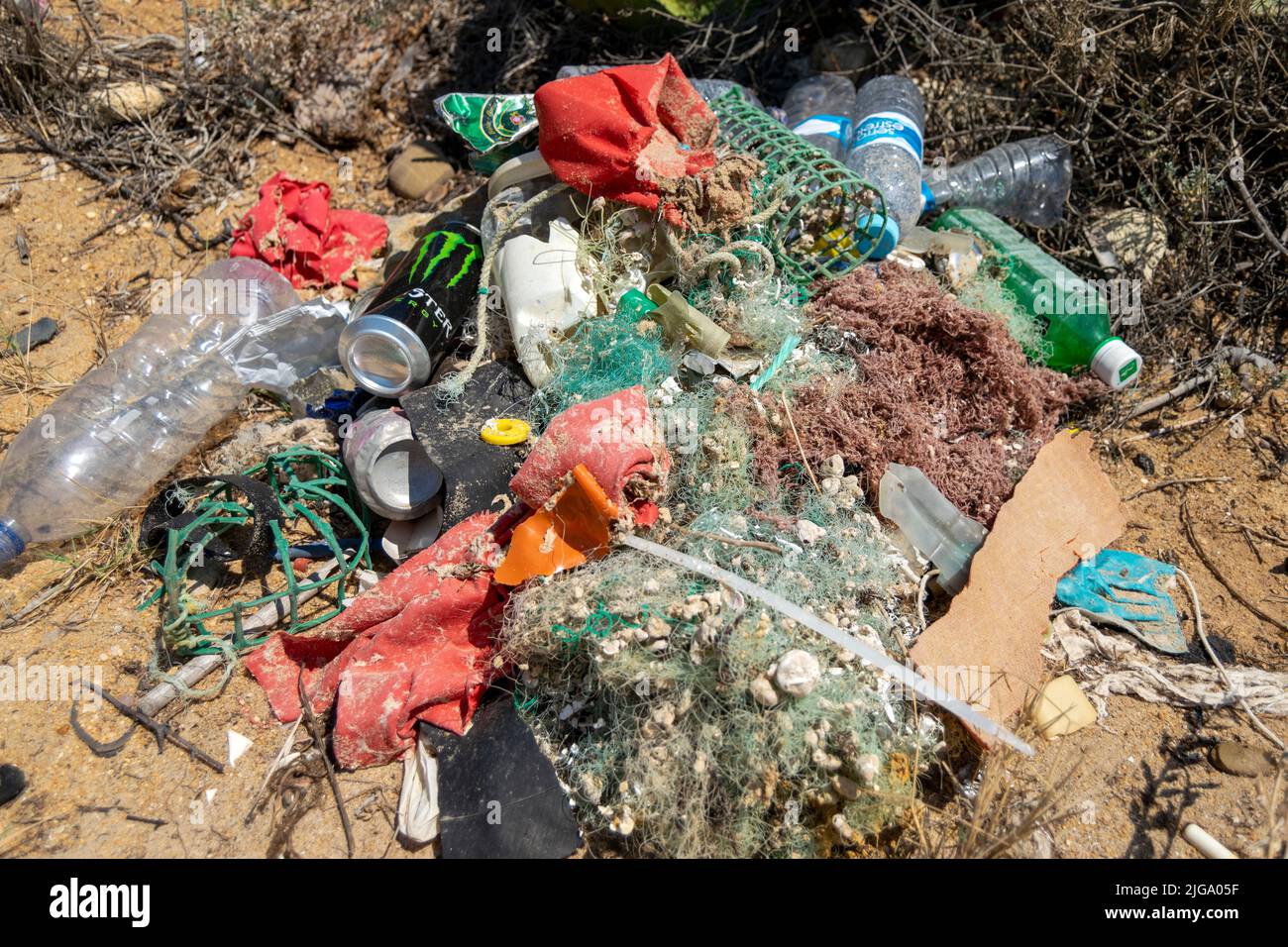Ocean pollution collected on beaches, pollution due to plastics, old nets, bottles and ropes. Saving the ocean from pollution. Collecting garbage. Stock Photo
