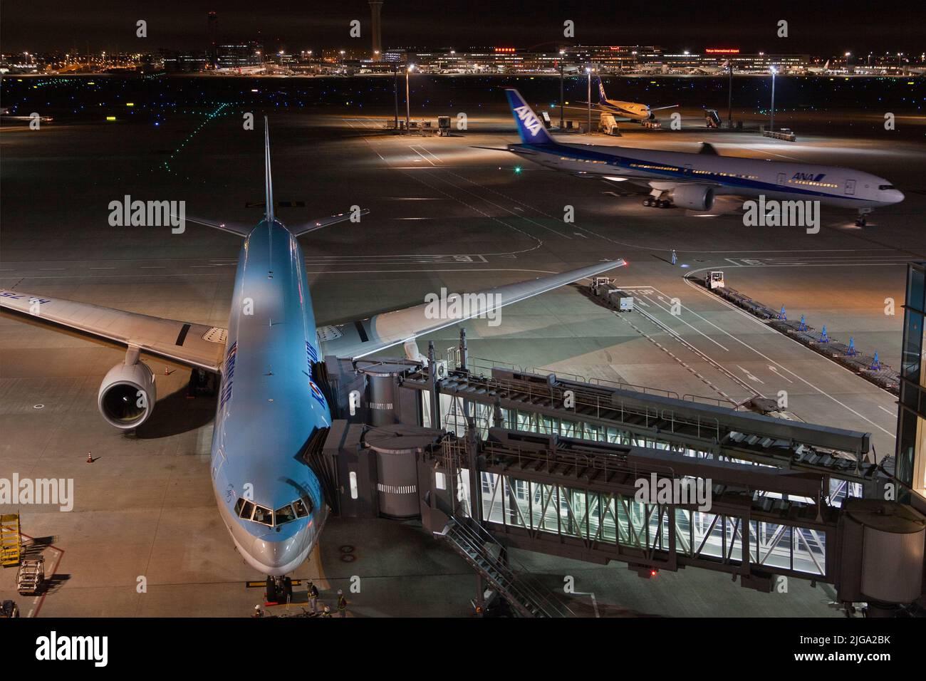 Airliners loading and taxiing at night, Haneda Airport, Tokyo, Japan Stock Photo