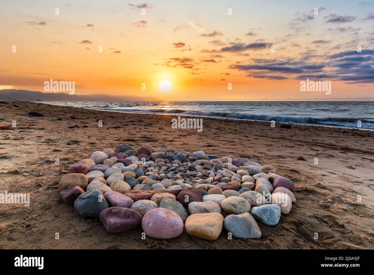 Ritual Stones For Spiritual Ceremony Are Are Arranged In A Circle During Sunset On The Beach Stock Photo
