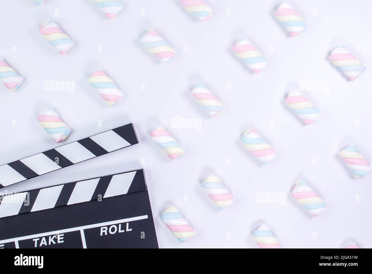 Movie clapperboard White background. White background with twisted marshmallow pattern. Mock up. Stock Photo