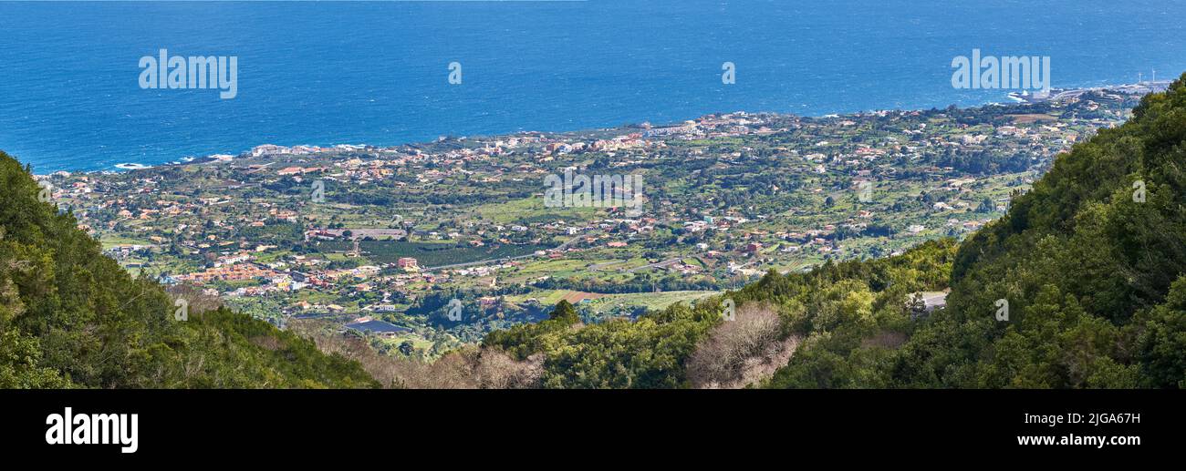 View of the coastal city, Puerto de Tazacorte, from the mountain with the sea in the background from above. Houses or holiday accommodation by the Stock Photo