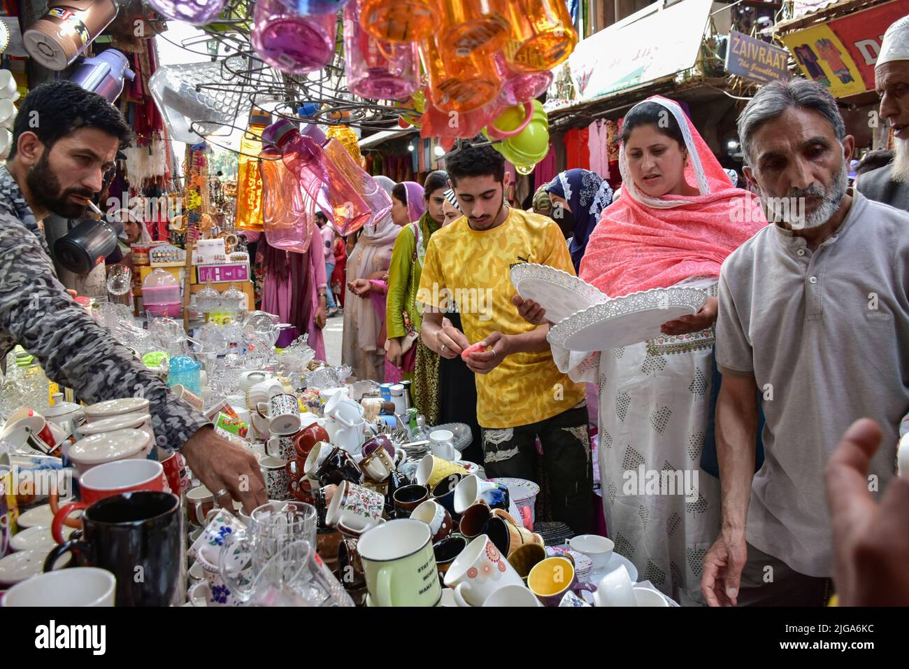 Srinagar, India. 08th July, 2022. Kashmiri residents shop ahead of the  Muslim festival Eid al-Adha at a local market. Markets across the Muslim  world witness huge shopping rush in preparation for Eid