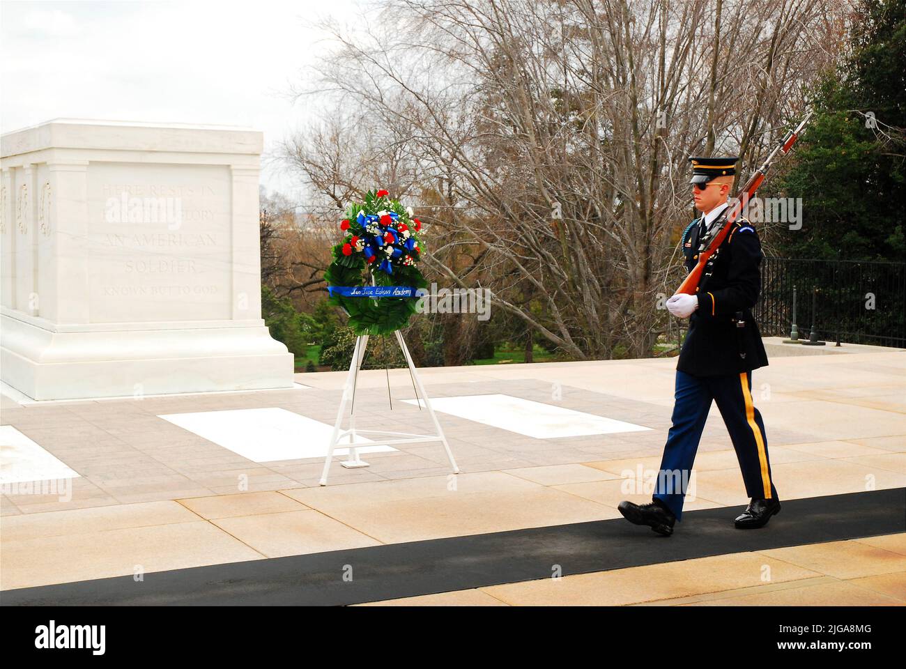 An honor guard paces in front of the Tomb of the Unknow Soldier, providing a ceremonial guard at the Arlington National Cemetery near Washington, DC Stock Photo