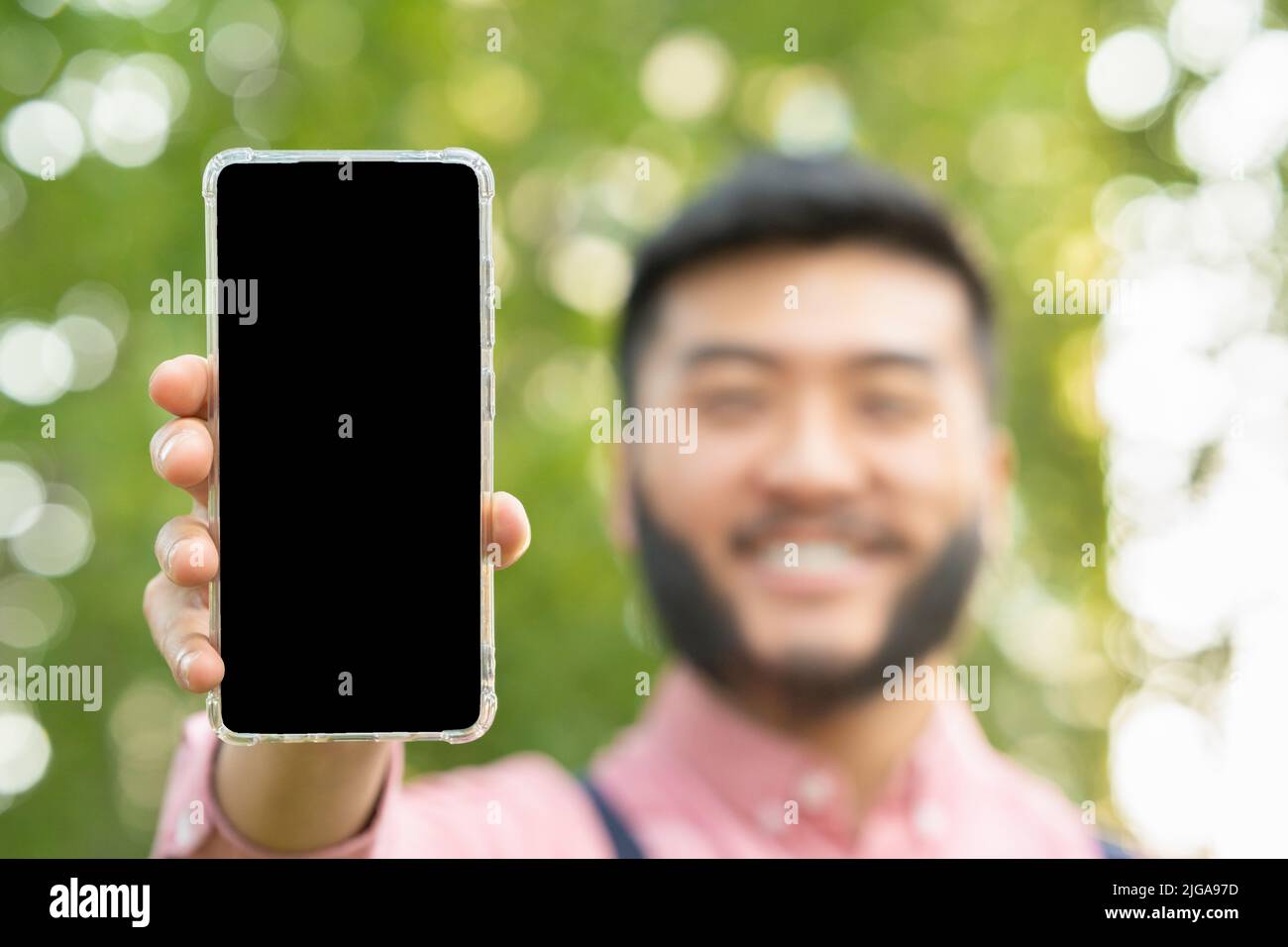 Screen of a mobile phone held by an man Stock Photo