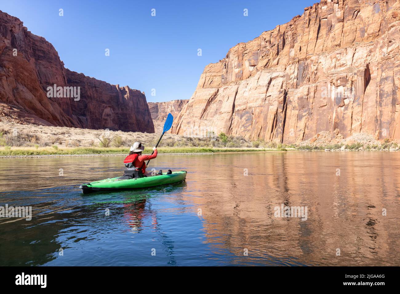 Adventurous Woman on a Kayak paddling in Colorado River. Glen Canyon