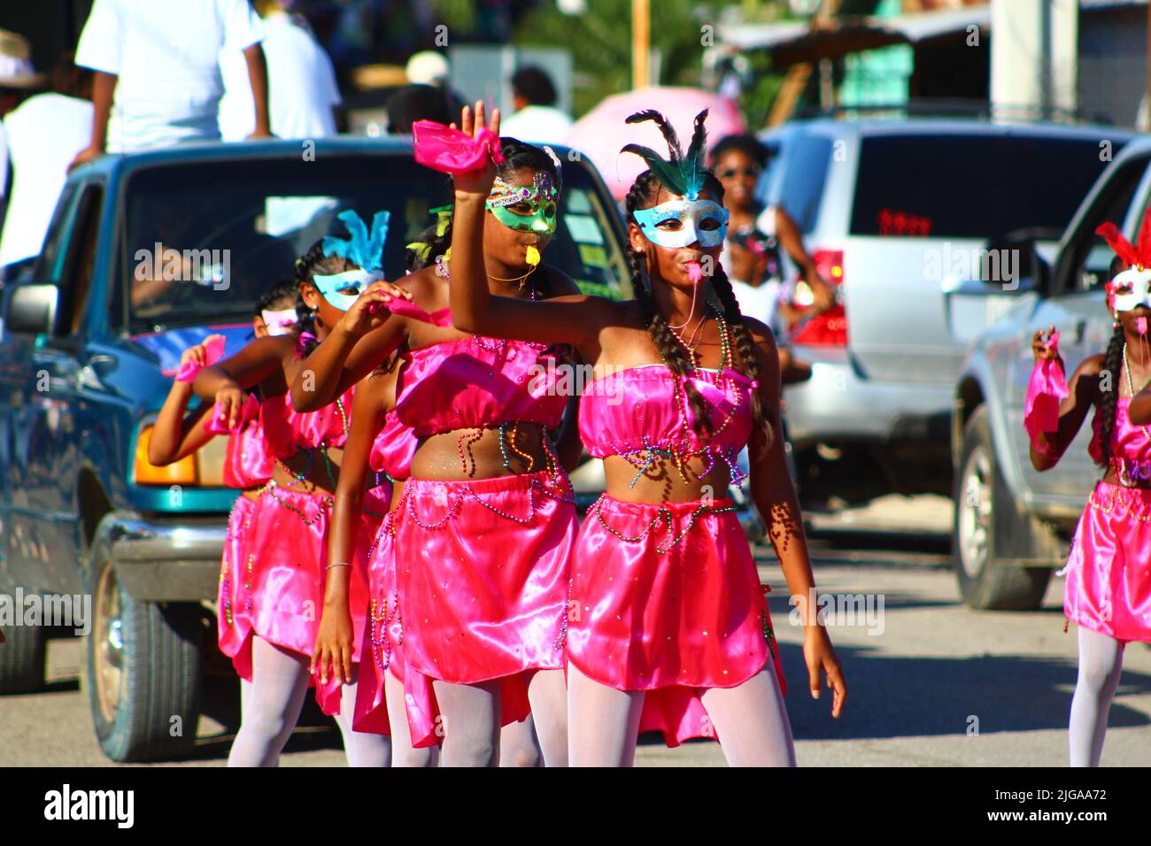 PUNTA GORDA, BELIZE - SEPTEMBER 10, 2016 St. George’s Caye Day celebrations and carnival line of girls in pink costumes with masks Stock Photo