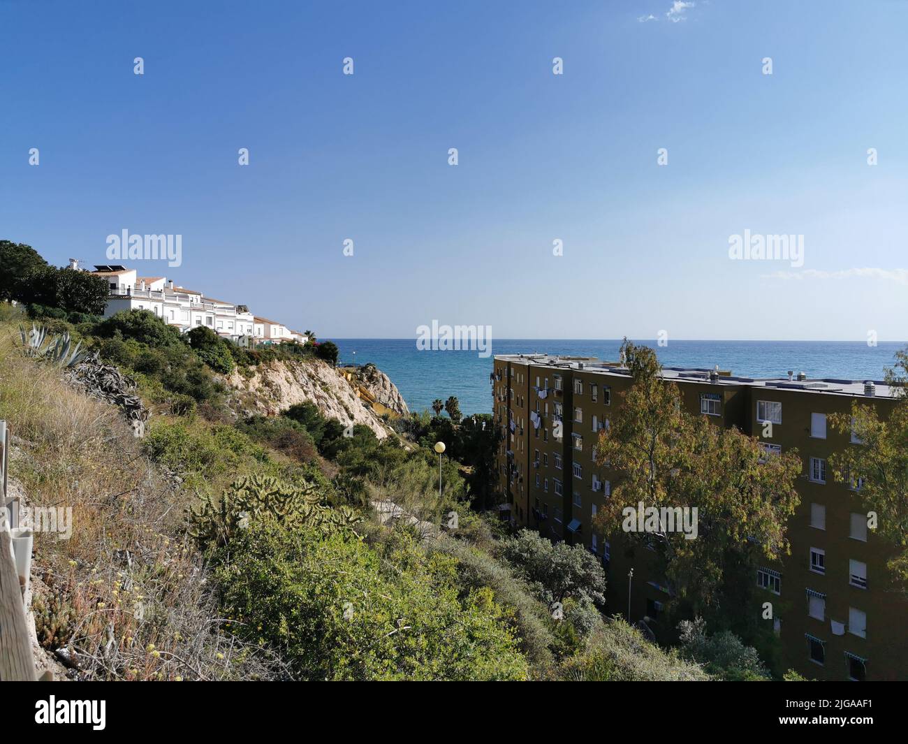 The beach and houses on the coast of La Cala del Moral, Spain during summertime Stock Photo