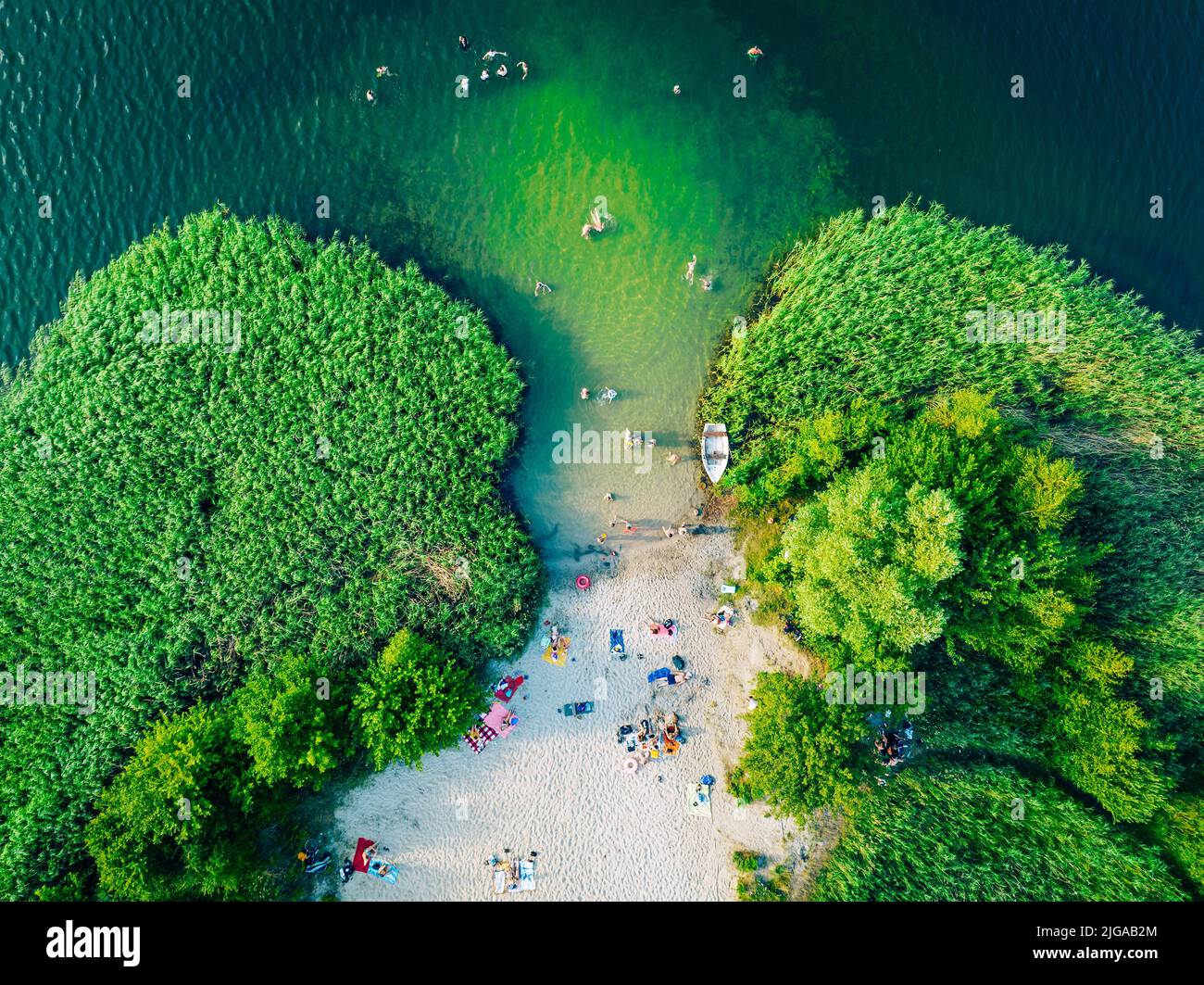Summer time at the lake. Rest on the beach. Aerial view of small hidden beach. - Stock Image