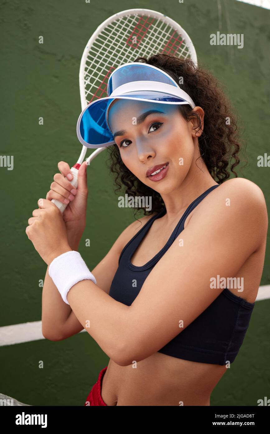 Ive mastered my technique. a female tennis player posing with a racket. Stock Photo
