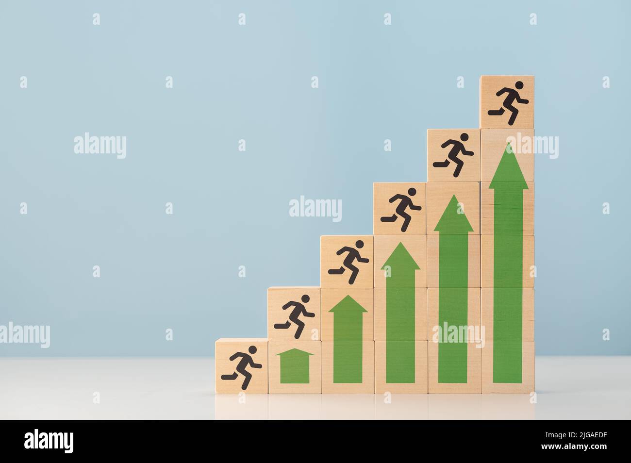ladder of success. up arrows showing growth and silhouette man on wooden cubes. Concept of success and achieving your goal. Ladder career path for bus Stock Photo
