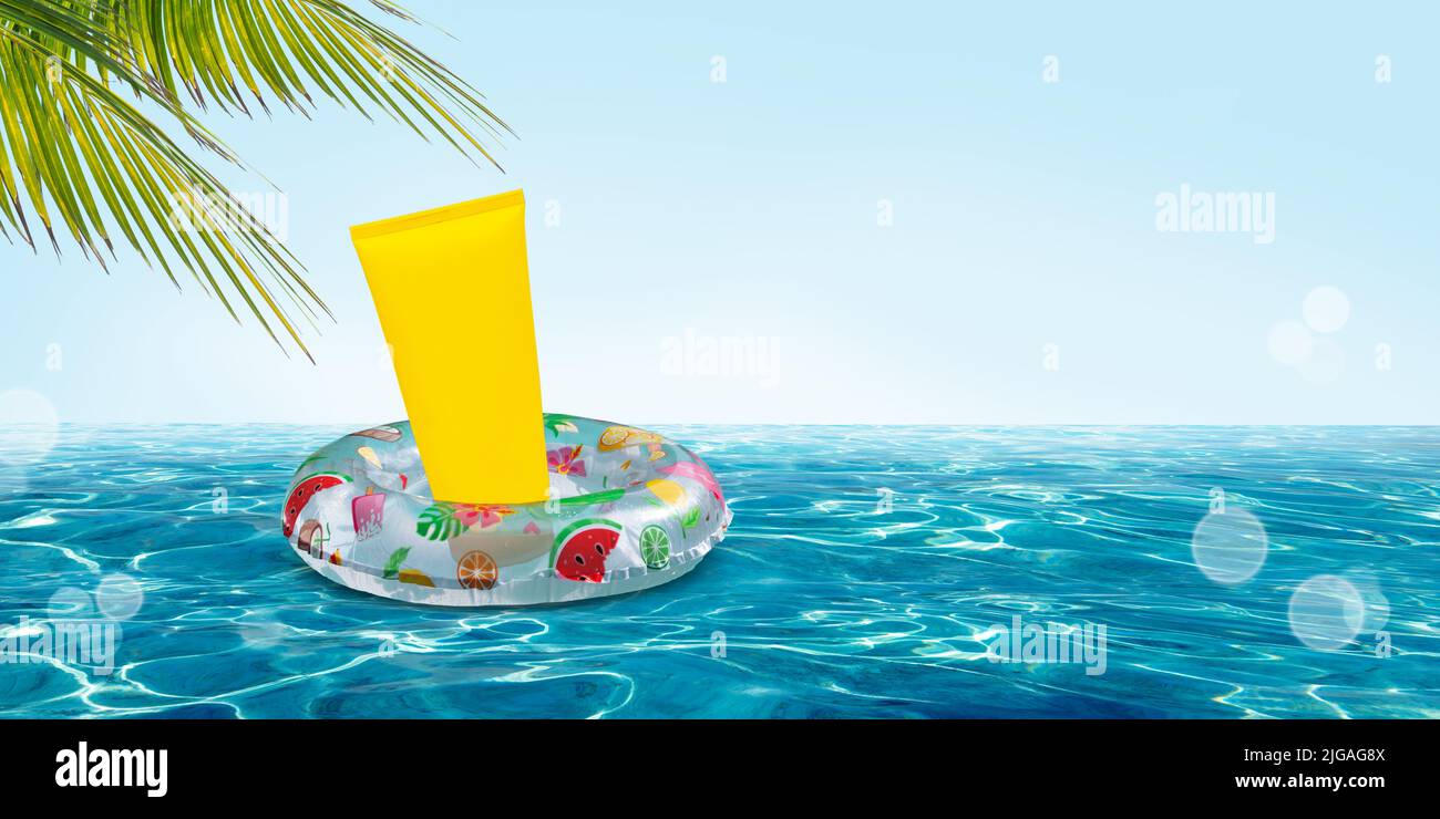 Summer skin protection concept with waterproof sun cream on a floating inflatable swim ring. Stock Photo