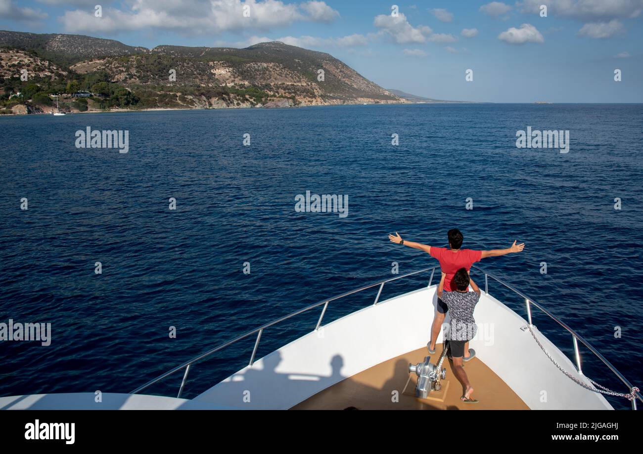 Teenager on a cruise boat in the sea enjoying the scenery. Akamas Peninsula, Paphos Cyprus Stock Photo