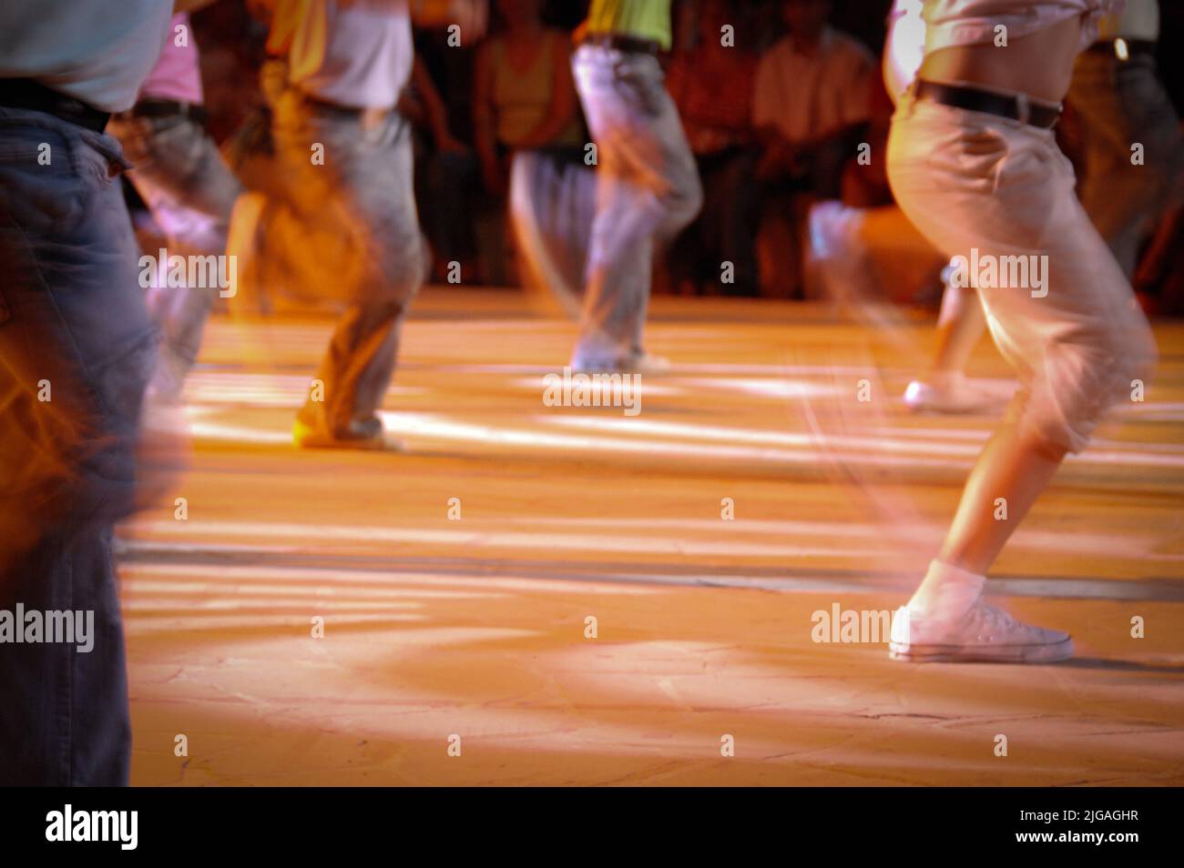 Unrecognized group of teenagers dancing on a stage. Blurred motion of dancers Stock Photo