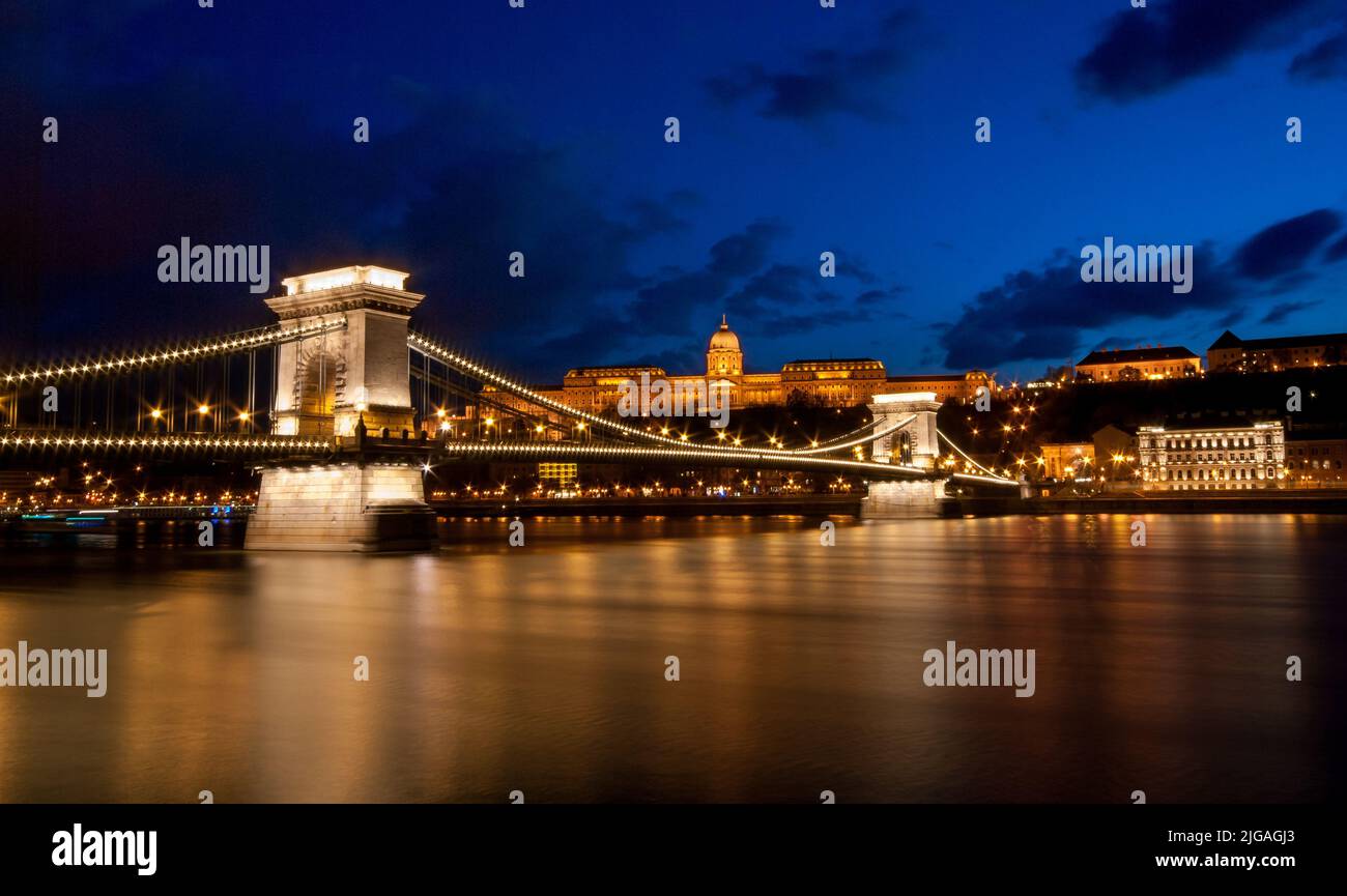 Royal Palace or the Buda Castle and the Chain Bridge after sunset in Budapest in Hungary. Stock Photo