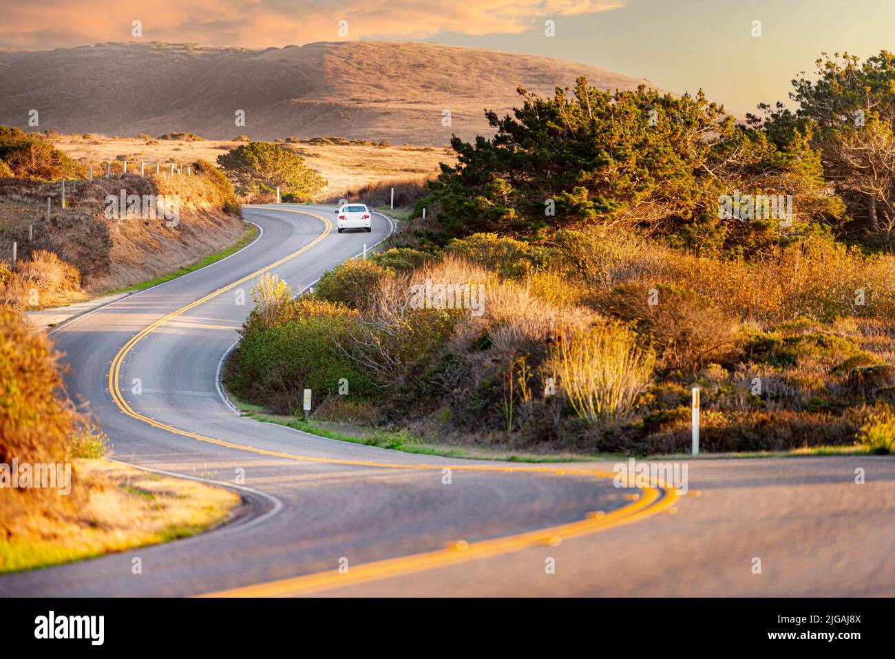 Car at highway, Big sur coast in California, United States of America. Mountains in background. Stock Photo